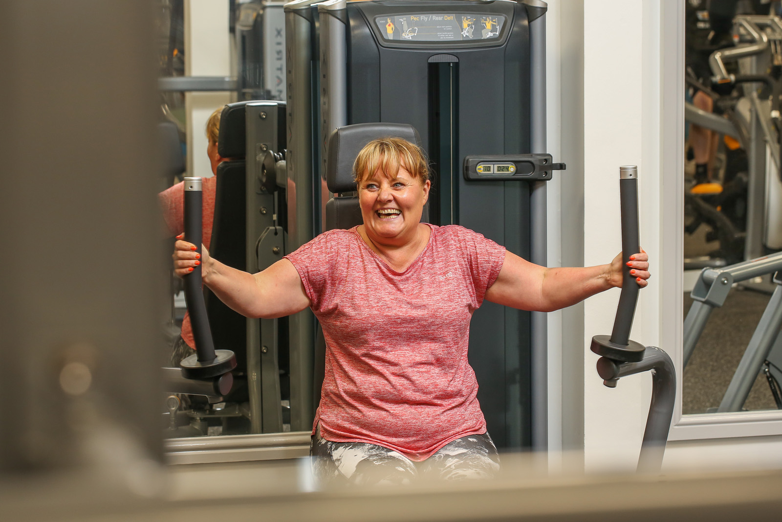 woman enjoying using gym equipment at Bury Leisure