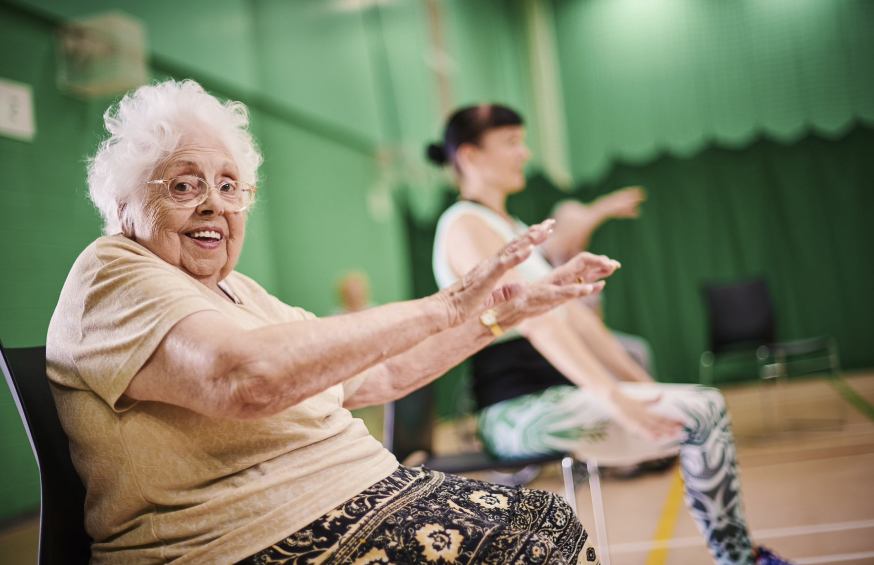 older woman participating in seated exercise at Your Trust Rochdale